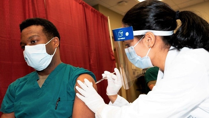 Image of Man getting vaccine.