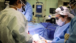 (From left) Army Lt. Col. Shimul Patel, chief, Plastic Surgery Services, Landstuhl Regional Medical Center, and U.S. Army Lt. Col. Jessica Peck, chief, Ear, Nose and Throat Clinic, LRMC, operate on a cancer patient during the first microvascular reconstruction and anastomosis procedure ever performed at LRMC, Dec. 3, 2021. 