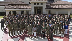 Military personnel pose for a picture