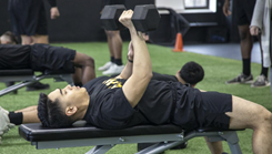 Military personnel bench pressing