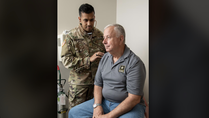 Maj. (Dr.) Avinash Chaurasia, radiation oncologist, examines Scott Anglin at Brooke Army Medical Center, Joint Base San Antonio-Fort Sam Houston