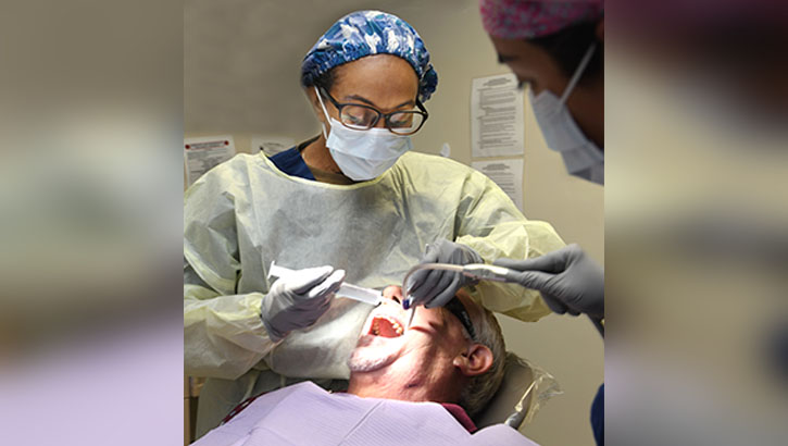 U.S. Navy Capt. Cecilia Brown, a maxillofacial oral surgeon at Naval Hospital Jacksonville Dental Clinic, provides care for a patient. Brown, a native of Sparta, Georgia, is the first African American female to complete the U.S. Navy Oral and Maxillofacial Surgical Residency program and the only African American oral surgeon in the Navy. Brown says, “Life is like a 4-way stop.” (U.S. Navy photo by Deidre Smith, Naval Hospital Jacksonville/Released)