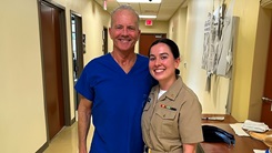 Retired U.S. Navy Capt. William Roberts and Navy Ensign Hannah Ortiz pose for picture