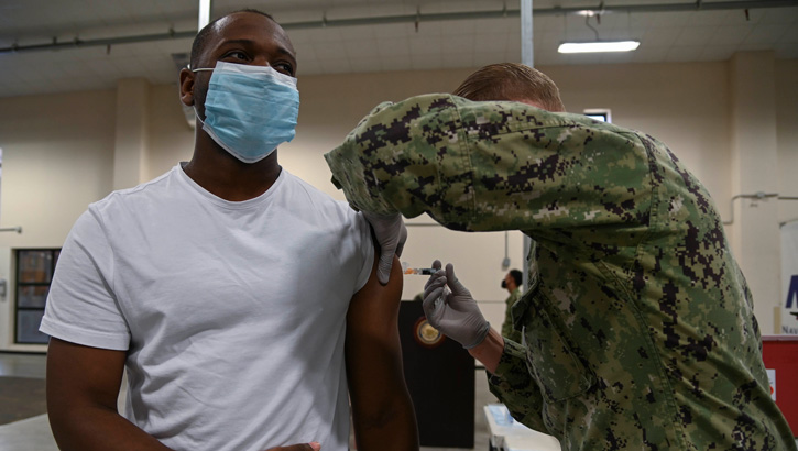 Image of A hospital corpsman administers an influenza vaccination to an airman as part of a seasonal shot exercise onboard Naval Air Station Sigonella.