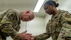 Military physical therapist guides soldier on follow up care. 