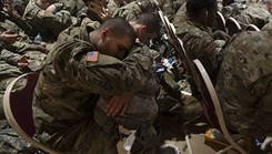 A trainee attempts to get a little sleep as he waits for transportation at the Joe E. Mann Ballroom Dec. 18. He is one of thousands of Initial Entry Training Soldiers across the Army who are headed home on leave for the holidays. 