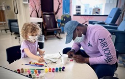 Military personnel coloring with children